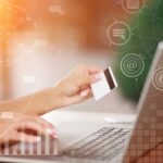 Hand with card laptop